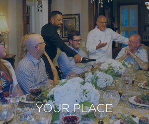 Mobile version of a dining room full of friends served dinner talking with the chef with the words YOUR PLACE across the image
