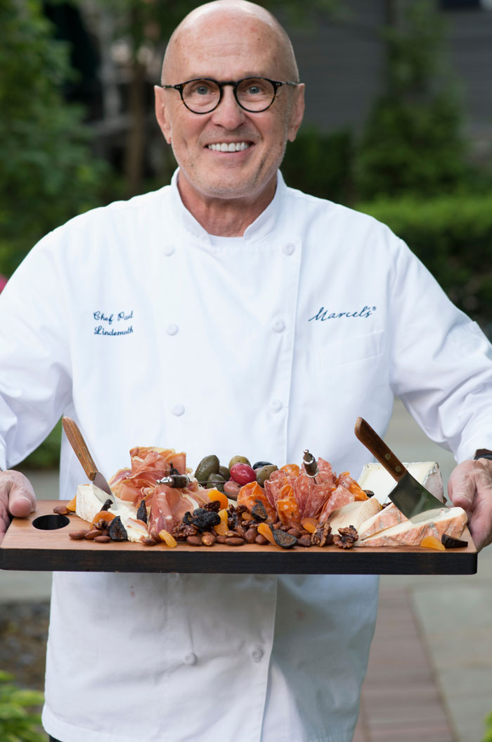 Chef Paul Lindemuth serves a cheese and charcuterie board at a MAISON event